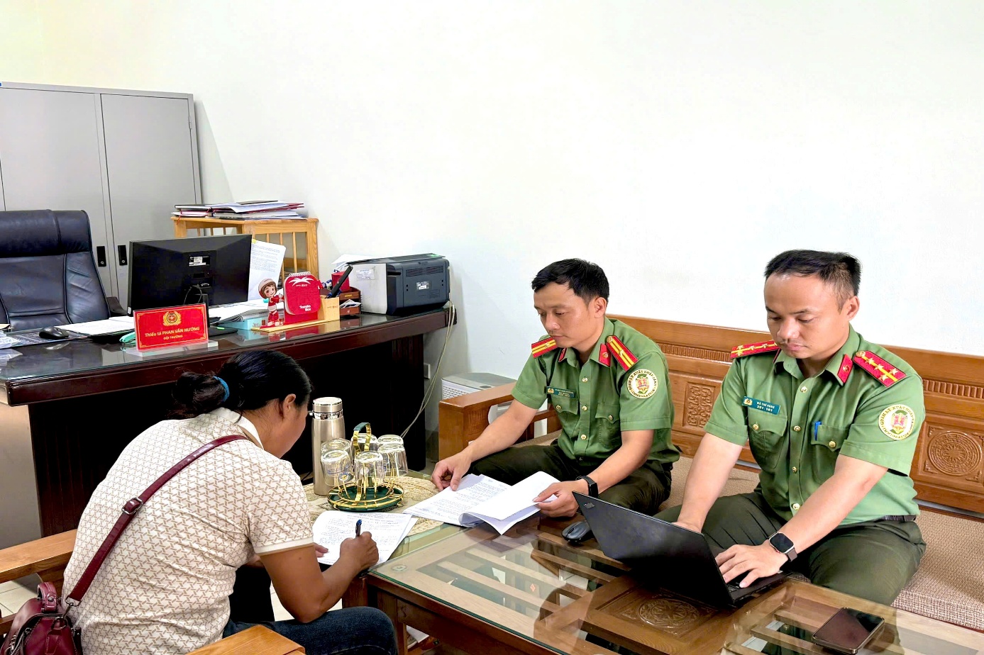 A group of people in uniform sitting at a tableDescription automatically generated
