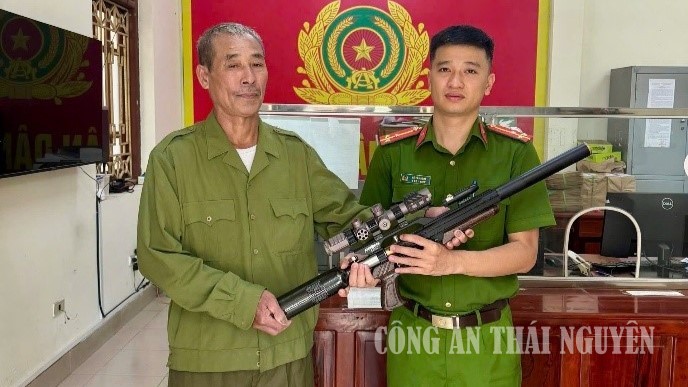 Cán bộ Công an phường tiếp nhận vũ khí do nhân dân giao nộp.