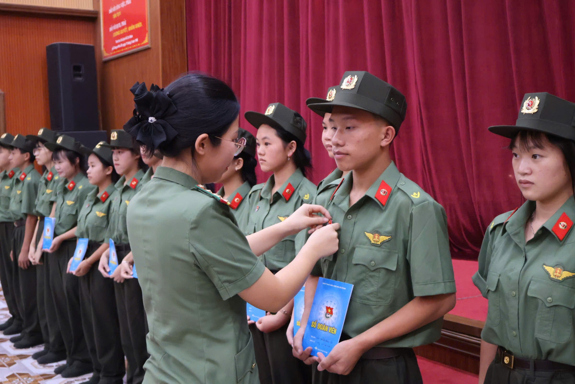 Ảnh 1: Đại diện Ban Chấp hành Đoàn trường trao sổ đoàn và huy hiệu đoàn cho các đoàn viên mới.