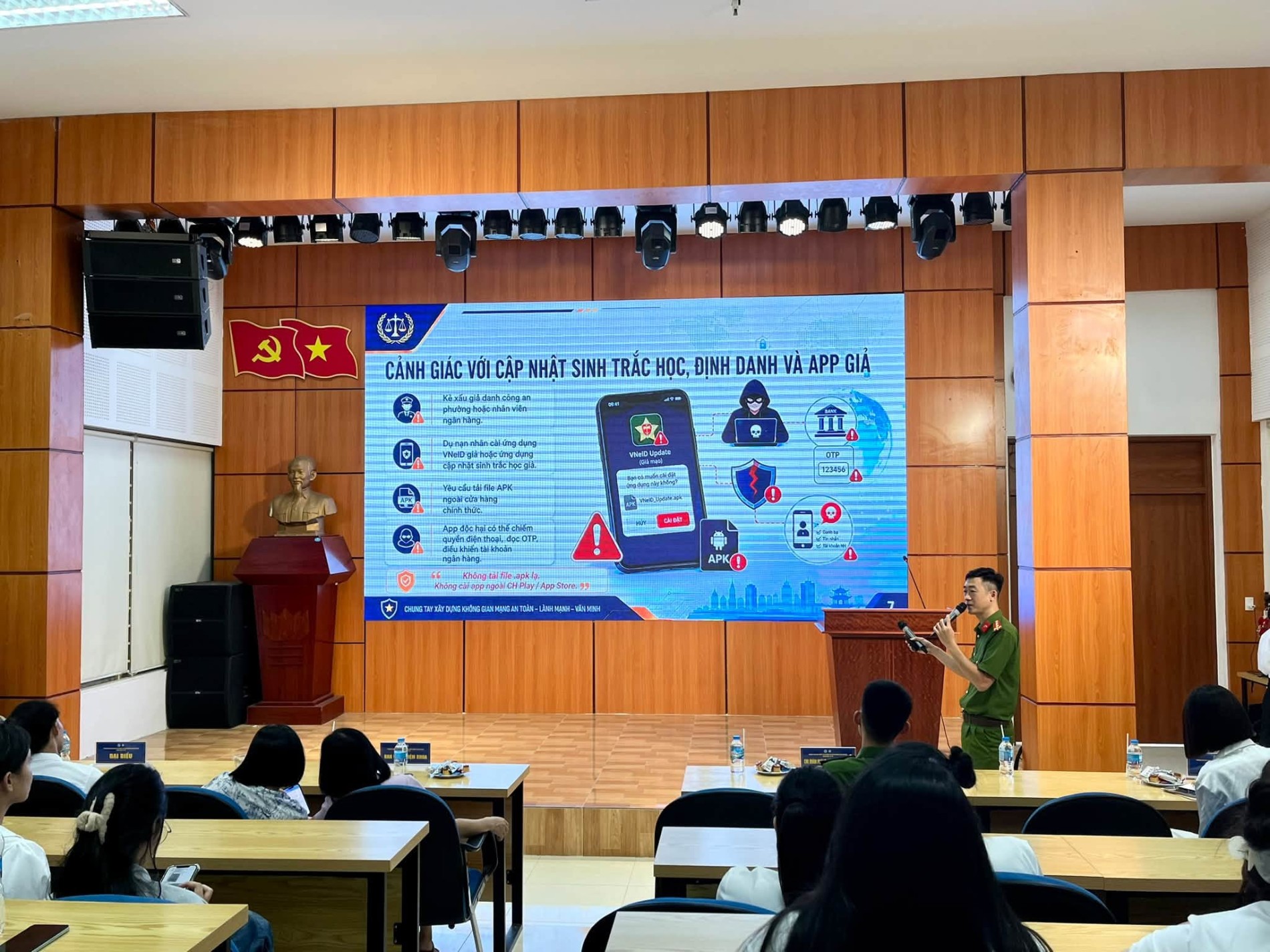 A person standing in front of a screenDescription automatically generated